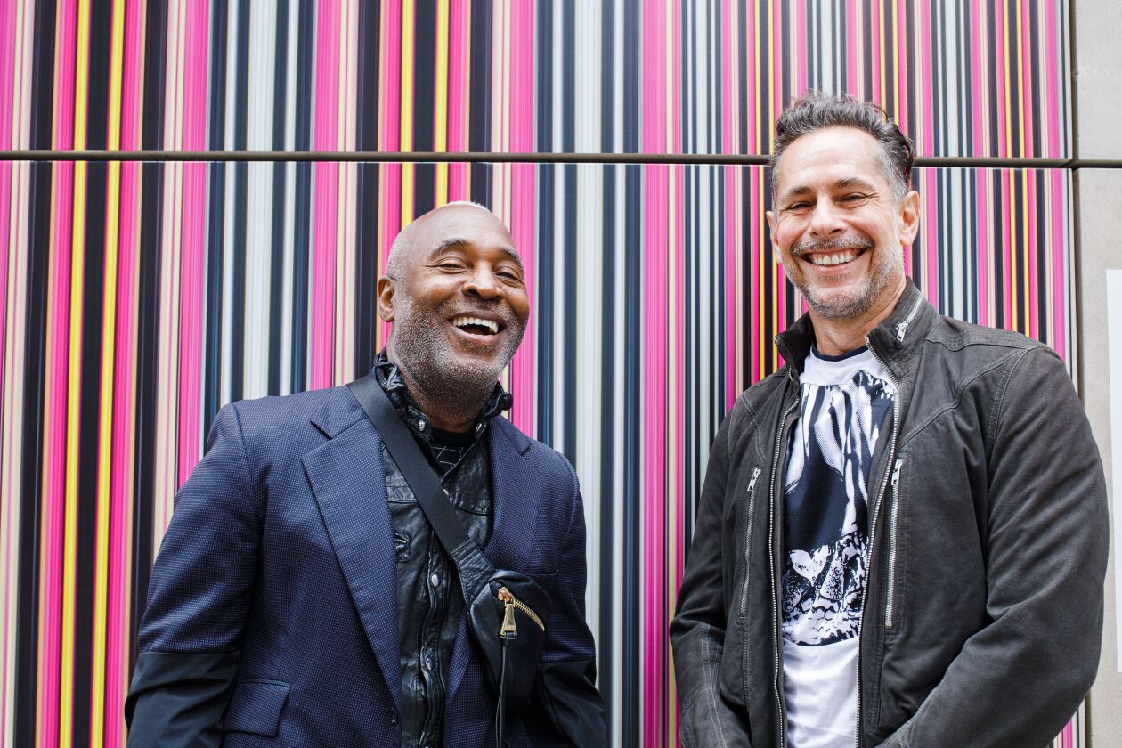 Nick Cave (left) and Bob Faust were on hand Tuesday for the debut of their mural “Rapt on The Mile” on Michigan Avenue. The artwork is installed on the outside of a former Apple retail store at 679 N. Michigan Ave.